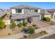 Charming two-story home featuring a beautifully landscaped front yard with a brick driveway, inviting and well-kept at 25725 S 230Th St, Queen Creek, AZ 85142