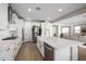 Bright kitchen featuring white cabinets, stainless appliances, a subway tile backsplash, and a large island at 25725 S 230Th St, Queen Creek, AZ 85142