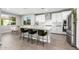 Modern kitchen with white cabinets, an island with counter seating, and a view to the dining room at 25725 S 230Th St, Queen Creek, AZ 85142