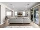 Open-concept living room with a couch and view to the backyard at 25725 S 230Th St, Queen Creek, AZ 85142