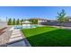 Resort-style backyard featuring pool, pristine turf and gorgeous stone decor at 25725 S 230Th St, Queen Creek, AZ 85142