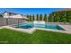 Beautiful pool with water feature surrounded by lush green artificial grass at 25725 S 230Th St, Queen Creek, AZ 85142