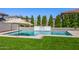 Outdoor pool area with a waterfall feature and low-maintenance artificial grass at 25725 S 230Th St, Queen Creek, AZ 85142