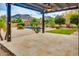 Expansive covered patio with scenic mountain views, lush landscaping, and a sparkling pool nearby and pavers at 26926 N 55Th Ln, Phoenix, AZ 85083