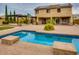 Expansive backyard featuring a pool, patio area with pergola, and well-manicured landscaping and solar panels at 26926 N 55Th Ln, Phoenix, AZ 85083