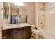 Bright bathroom with vanity, toilet, and tub with shower at 26926 N 55Th Ln, Phoenix, AZ 85083