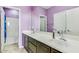 Elegant bathroom features double sinks, a large mirror, and modern fixtures, with a toilet in the corner at 26926 N 55Th Ln, Phoenix, AZ 85083