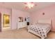 Pink carpeted bedroom with window and ensuite bathroom at 26926 N 55Th Ln, Phoenix, AZ 85083