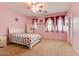 Cozy bedroom with carpeted floors, windows with curtains, closet, and ceiling fan at 26926 N 55Th Ln, Phoenix, AZ 85083