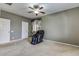 Neutral carpeted bedroom with a massage chair, ceiling fan, and a serene ambiance at 26926 N 55Th Ln, Phoenix, AZ 85083