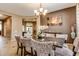 Elegant dining room with a modern chandelier and decor, perfect for Gathering meals and entertaining guests at 26926 N 55Th Ln, Phoenix, AZ 85083