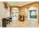 Spacious foyer with neutral tile flooring, arched doorways, and stylish decor sets a welcoming tone for the home at 26926 N 55Th Ln, Phoenix, AZ 85083
