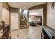 Foyer with tile flooring, staircase and view to a dining area at 26926 N 55Th Ln, Phoenix, AZ 85083