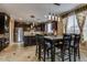 Dining area featuring a kitchen with stainless steel appliances and dark wood cabinets at 26926 N 55Th Ln, Phoenix, AZ 85083