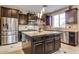 Kitchen island with granite countertops, stainless steel appliances, and pendant lighting at 26926 N 55Th Ln, Phoenix, AZ 85083