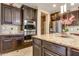 Close-up of a kitchen with stainless steel appliances and a granite countertop island at 26926 N 55Th Ln, Phoenix, AZ 85083