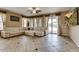 Spacious living room with a large sectional sofa and sliding glass doors to backyard at 26926 N 55Th Ln, Phoenix, AZ 85083