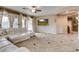 Bright living room featuring a large sectional sofa, tile floors, and neutral wall paint at 26926 N 55Th Ln, Phoenix, AZ 85083