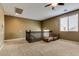 Carpeted loft area, featuring a ceiling fan and seating at 26926 N 55Th Ln, Phoenix, AZ 85083