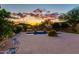 Sparkling pool area with mature landscaping and mountain backdrop, creating a serene outdoor oasis as the sunsets at 26926 N 55Th Ln, Phoenix, AZ 85083