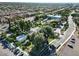 Aerial view of a neighborhood and recreational area with mature trees, a parking lot, and a tennis court at 2721 E Tamarisk St, Gilbert, AZ 85296