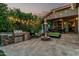 Outdoor kitchen and patio with grill, bar, fire pit, and lights perfect for relaxing or entertaining guests at 2721 E Tamarisk St, Gilbert, AZ 85296