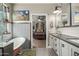 Well-lit bathroom featuring a soaking tub, dual vanity, and modern fixtures at 2721 E Tamarisk St, Gilbert, AZ 85296