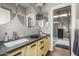 A quirky bathroom featuring double sinks, granite countertops, unique mirrors, and tile backsplash at 2721 E Tamarisk St, Gilbert, AZ 85296