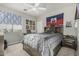 Comfortable bedroom featuring stylish decor, a ceiling fan, and a gray bed frame and comforter at 2721 E Tamarisk St, Gilbert, AZ 85296