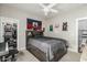 A cozy bedroom with a platform bed with storage, a ceiling fan and walk-in closet at 2721 E Tamarisk St, Gilbert, AZ 85296