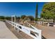 View of the community garden surrounded by a white fence on a sunny day with a clear blue sky at 2721 E Tamarisk St, Gilbert, AZ 85296
