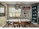 Bright dining room featuring stylish wallpaper, modern lighting, open shelving, and a large dining table at 2721 E Tamarisk St, Gilbert, AZ 85296