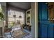 Inviting front porch featuring stylish tile, cozy seating, plants, and decor, creating a welcoming outdoor space at 2721 E Tamarisk St, Gilbert, AZ 85296
