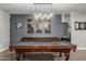 Elegant game room featuring a stylish pool table, unique lighting fixtures, and sophisticated decor at 2721 E Tamarisk St, Gilbert, AZ 85296