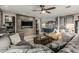 Open living space with a large grey sofa, modern wood accents, and an open view of the kitchen at 2721 E Tamarisk St, Gilbert, AZ 85296