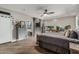 Relaxing main bedroom with wood floors, decorative ceiling fan and ensuite bathroom at 2721 E Tamarisk St, Gilbert, AZ 85296