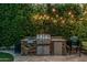 Outdoor kitchen featuring a built-in grill with a stainless steel finish and stone accents at 2721 E Tamarisk St, Gilbert, AZ 85296