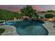 Stunning backyard pool with a rock waterfall feature, spa, and beautiful landscaping at 2721 E Tamarisk St, Gilbert, AZ 85296