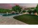A beautiful pool and landscaped yard with a built-in waterfall feature and mature trees at 2721 E Tamarisk St, Gilbert, AZ 85296