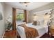 Cozy bedroom with hardwood floors, a large window, and a stylish headboard at 2823 E Charlotte Dr, Phoenix, AZ 85024