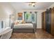 Comfortable bedroom with a daybed, large wardrobe, and a bright window at 2823 E Charlotte Dr, Phoenix, AZ 85024