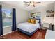 Bright bedroom with hardwood floors, desk area, and a large window offering natural light at 2823 E Charlotte Dr, Phoenix, AZ 85024
