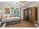 Comfortable bedroom with a daybed, large wardrobe, and a bright window at 2823 E Charlotte Dr, Phoenix, AZ 85024