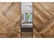 Stylish view of barn doors opening into a bedroom with ample natural light at 2823 E Charlotte Dr, Phoenix, AZ 85024