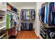 Walk-in closet with ample shelving, organized hanging space, and warm wood flooring at 2823 E Charlotte Dr, Phoenix, AZ 85024
