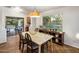 Bright dining area features a wooden table, four chairs, and a sliding door to the backyard at 2823 E Charlotte Dr, Phoenix, AZ 85024