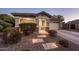 Charming single-story home showcasing stone accents, a manicured front yard, and a well-lit walkway to the front door at 2823 E Charlotte Dr, Phoenix, AZ 85024