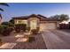 Inviting single-story home featuring stone accents, a landscaped front yard, and a driveway leading to an attached garage at 2823 E Charlotte Dr, Phoenix, AZ 85024