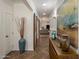Bright hallway featuring stylish barn doors, tiled floors, and decorative accents at 2823 E Charlotte Dr, Phoenix, AZ 85024