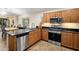 Bright kitchen with stainless steel appliances, wooden cabinets, and a view of the dining area at 2823 E Charlotte Dr, Phoenix, AZ 85024